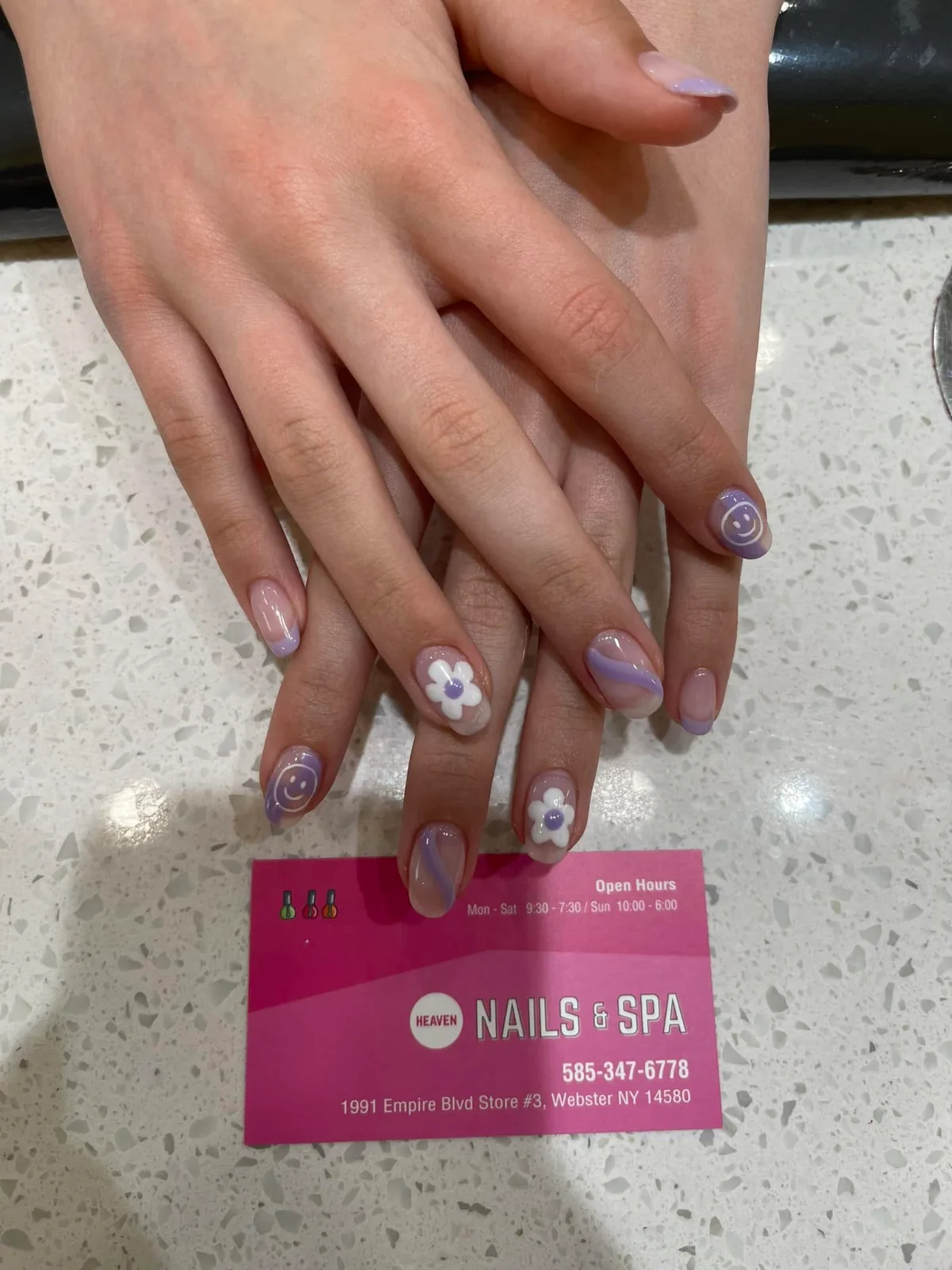 Lavender French tips with white daisies and smiley faces